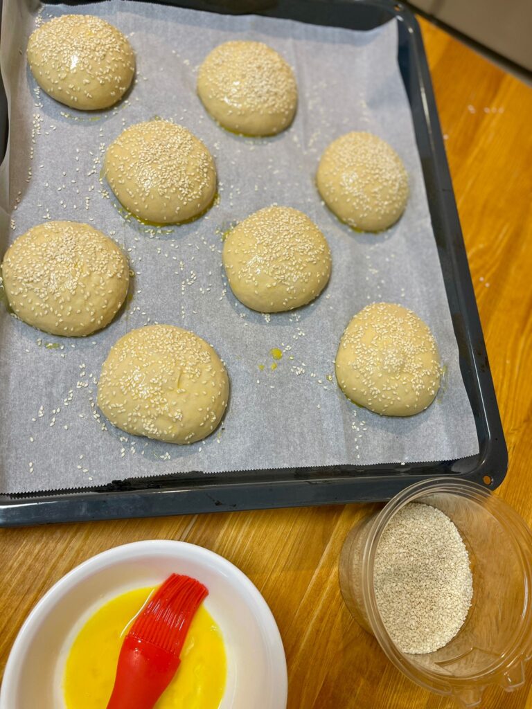 brushing egg-wash on hamburger buns